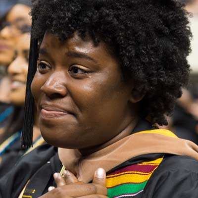 an emotional v.c.u. graduate smiling at their graduation ceremony
